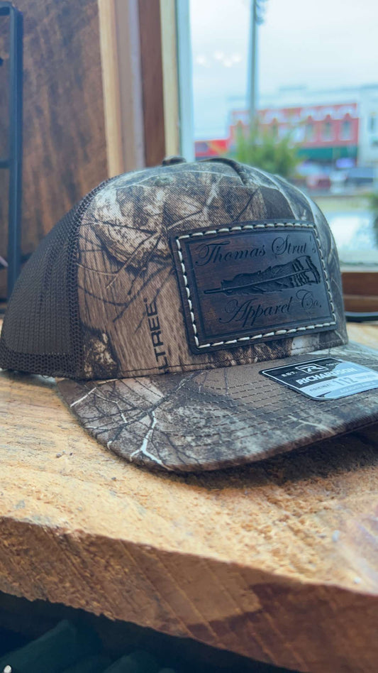 Men's Thomas Strut's Apparel Co. Stitched Leather Patch Trucker Hat-Realtree Edge/Brown